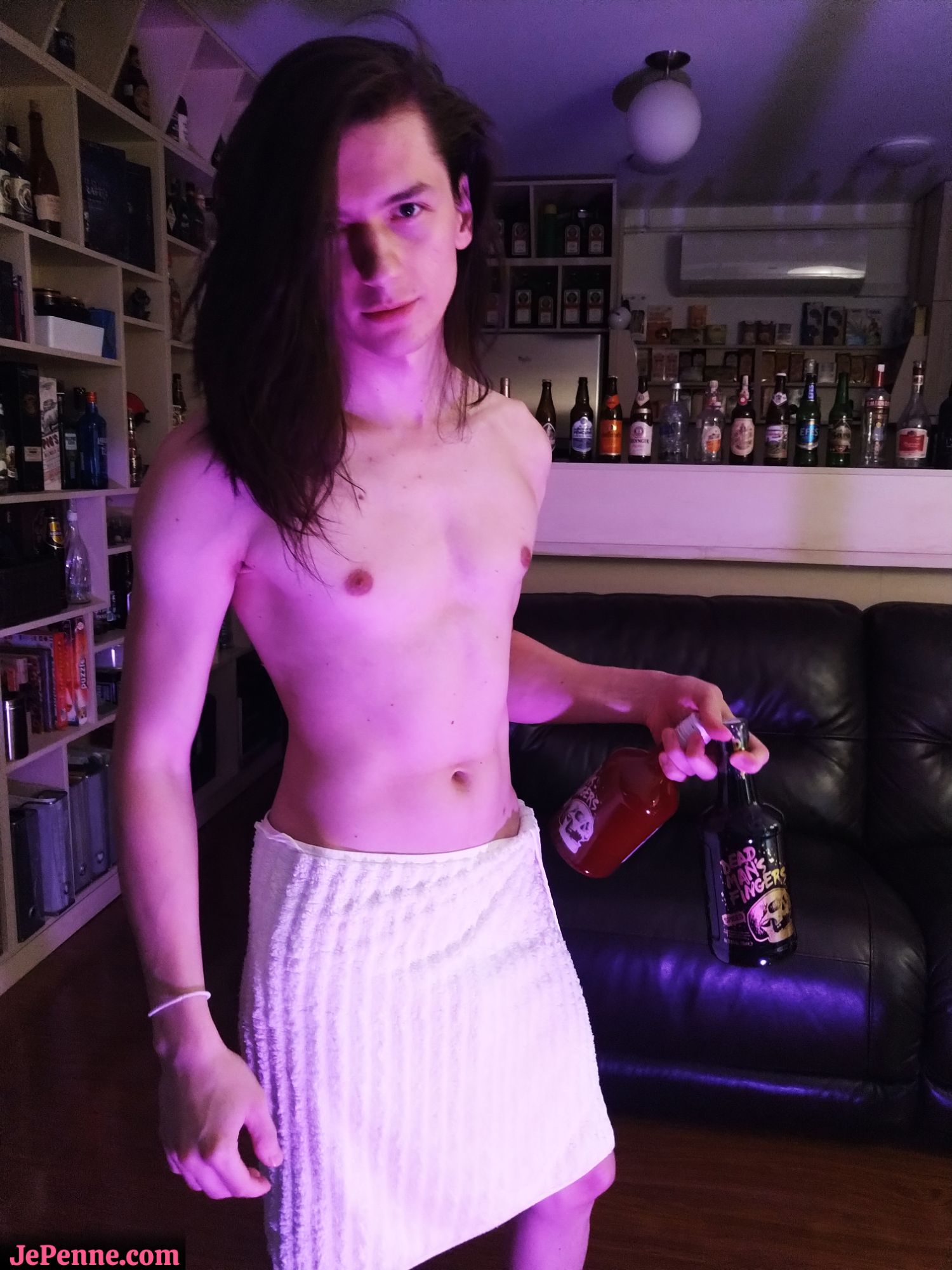 JePenne (slim, fit, long dark hair) with only a towel to hide his manly parts is holding 2 drinks.